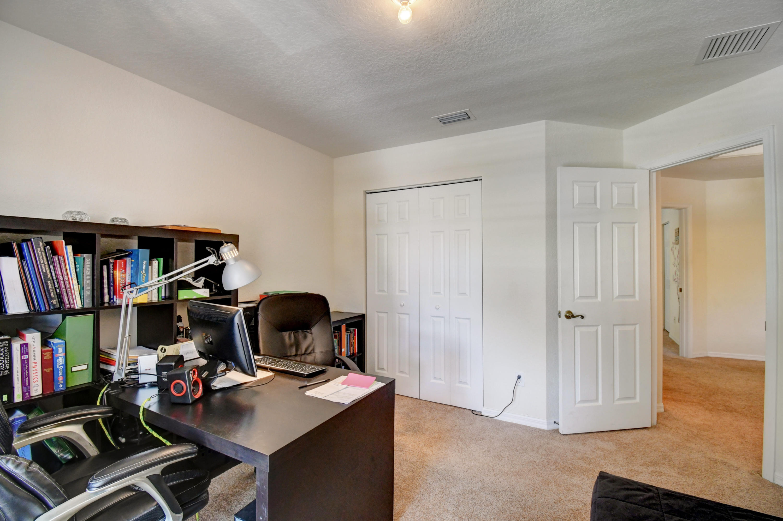 804 Quartz Terrace West Palm Beach, FL 33413 - Photo 41 of 65 a view of a workspace with furniture and a book shelf