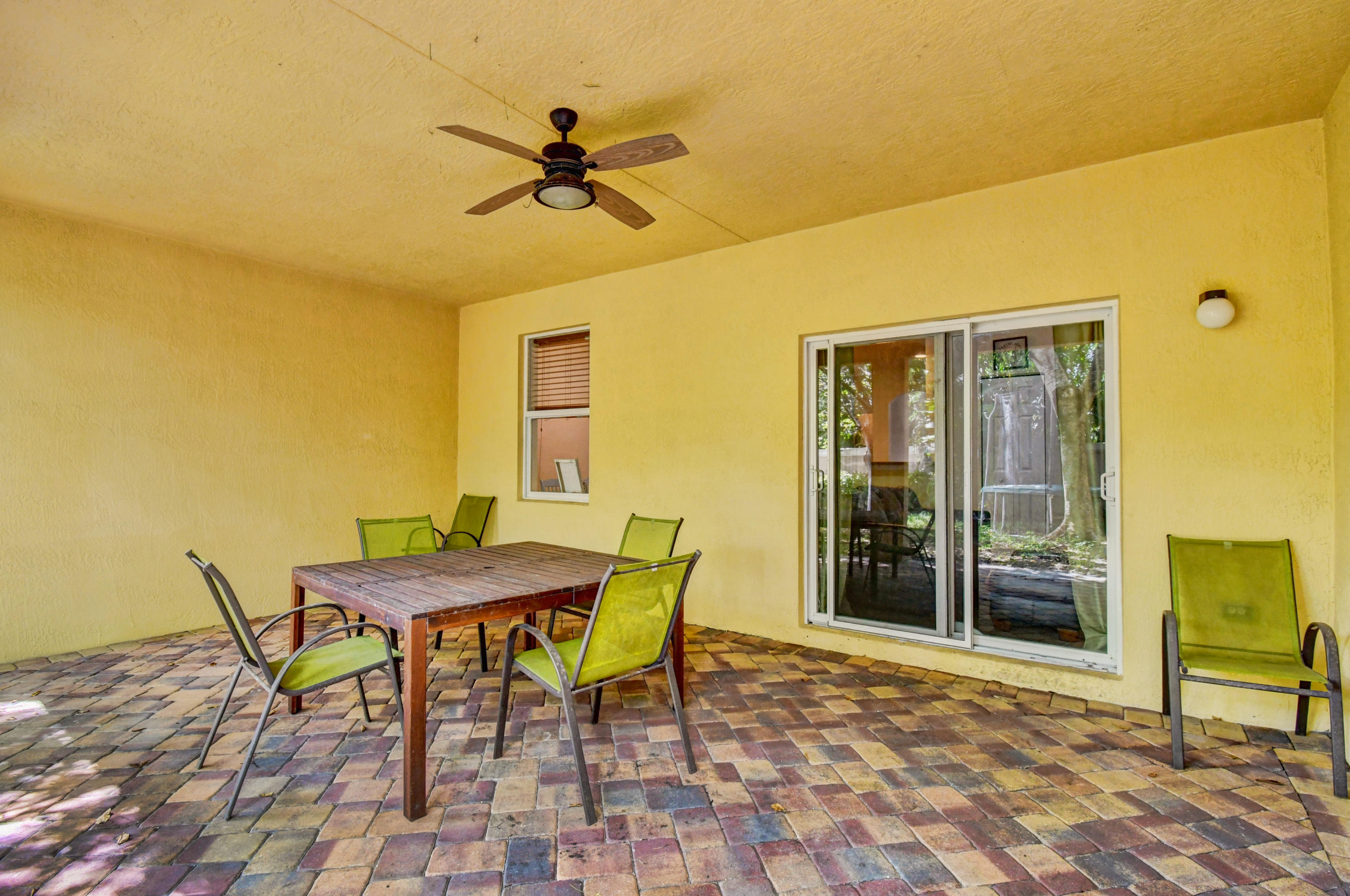 804 Quartz Terrace West Palm Beach, FL 33413 - Photo 46 of 65 a view of a patio with table and chairs with wooden floor