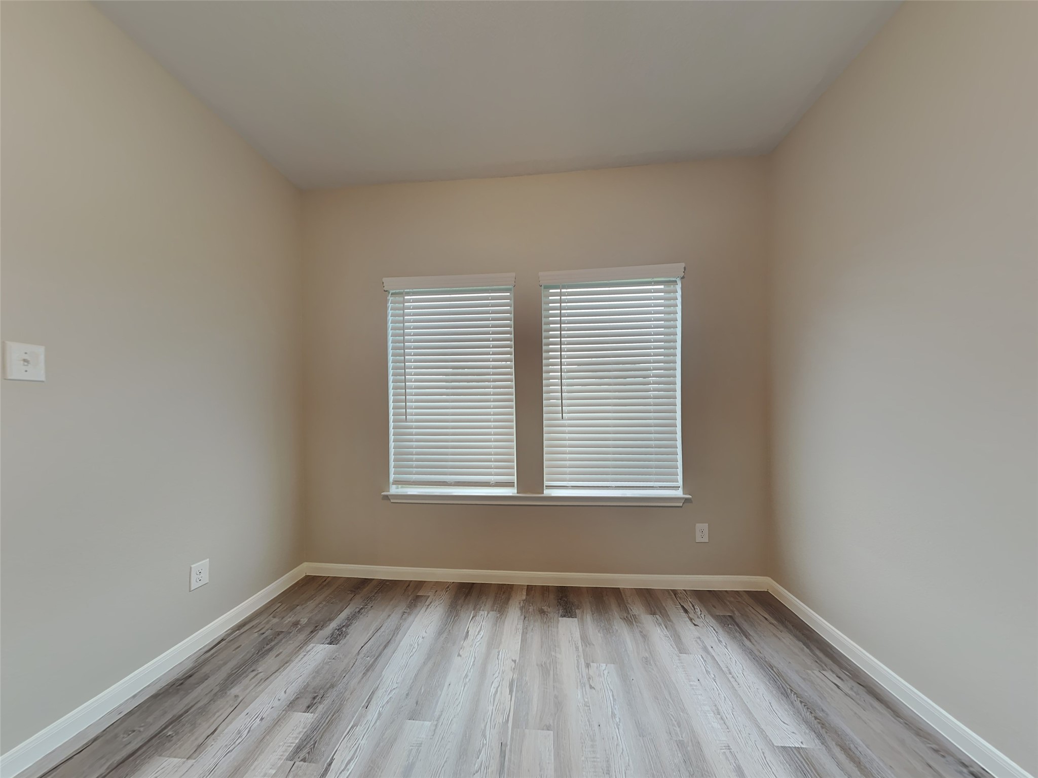227 Murrieta Lane Rosharon, TX 77583 - Photo 3 of 16 an empty room with wooden floor and windows