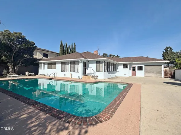 front view of a house with a yard table and chairs