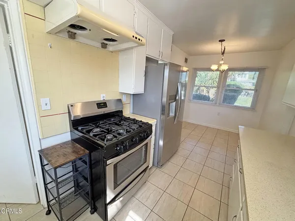 a kitchen with a stove and a refrigerator