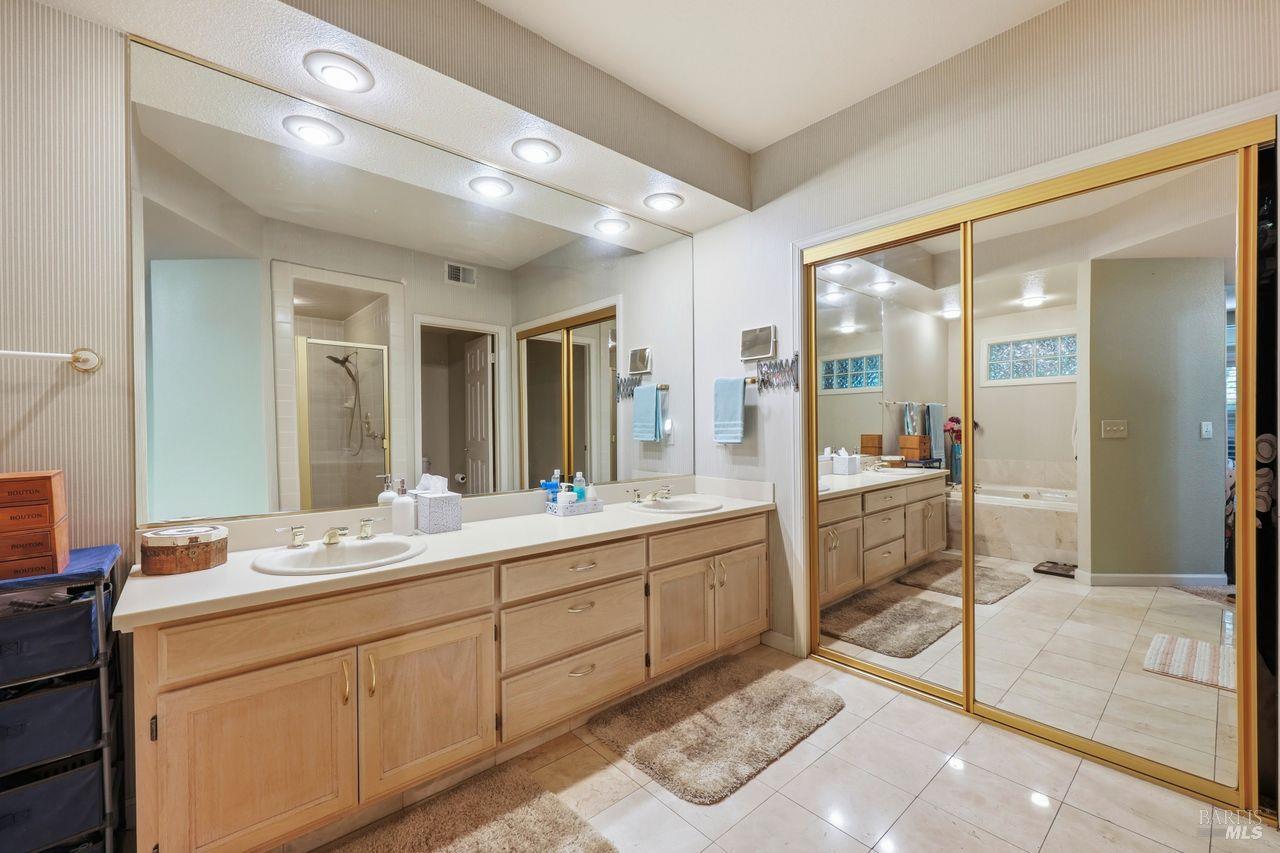2092 Stonefield Lane Santa Rosa, CA 95403 - Photo 26 of 44 a bathroom with a double vanity sink mirror and shower