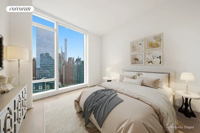 a bedroom with a large bed and a large window