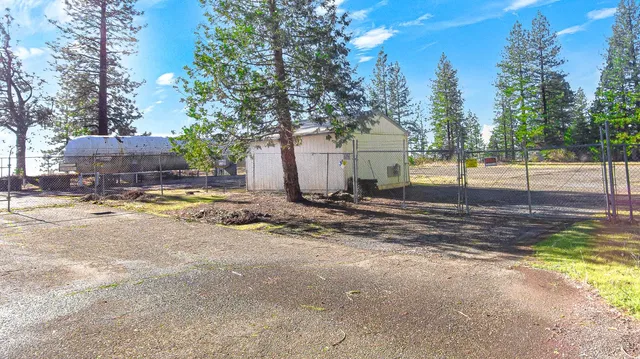 a view of a house with a yard and tree s
