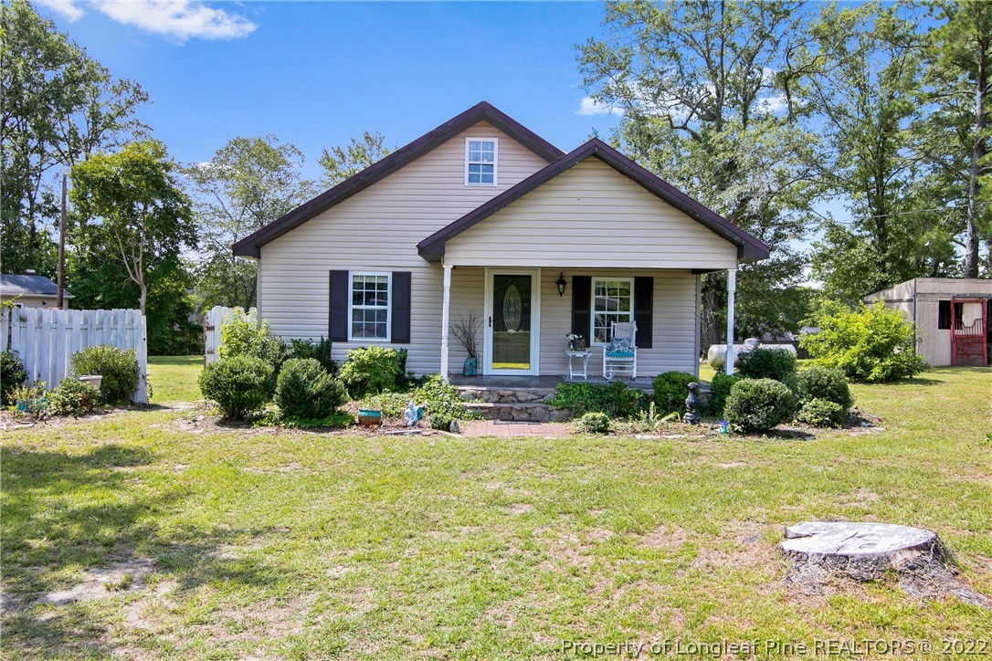 2574 Rockfish Road Raeford, NC 28376 - Photo 1 of 25 a front view of a house with a yard