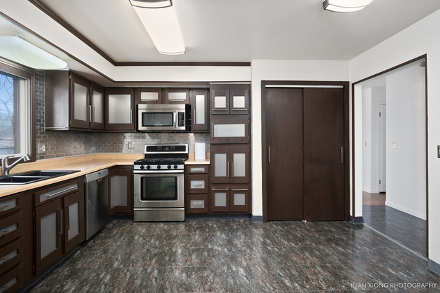 52 Neil Road Sugar Grove, IL 60554 - Photo 3 of 26 a kitchen with stainless steel appliances granite countertop a stove and a refrigerator