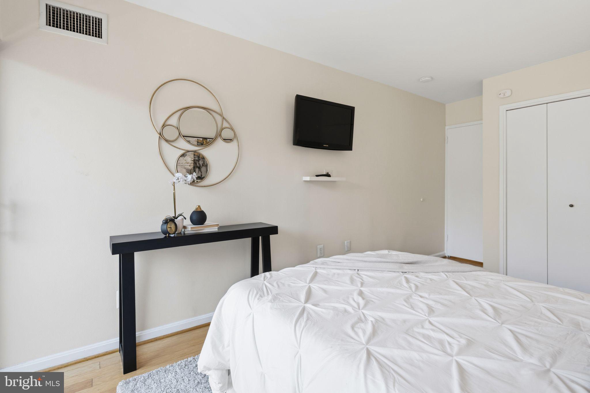 3225 Grace Street Northwest, Unit 226 Washington, DC 20007 - Photo 29 of 45 a bedroom with a bed and a flat screen tv