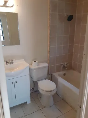 a white toilet sitting next to a bathroom sink
