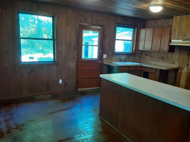 a kitchen with stainless steel appliances a refrigerator sink and cabinets