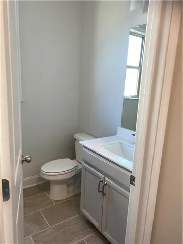 a white toilet sitting next to a bathroom sink