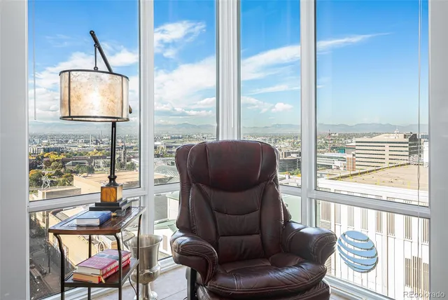 a living room with furniture and a floor to ceiling window