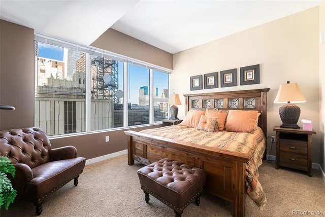 a bedroom with a bed and glass window