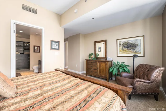 a bedroom with a bed couch and a window