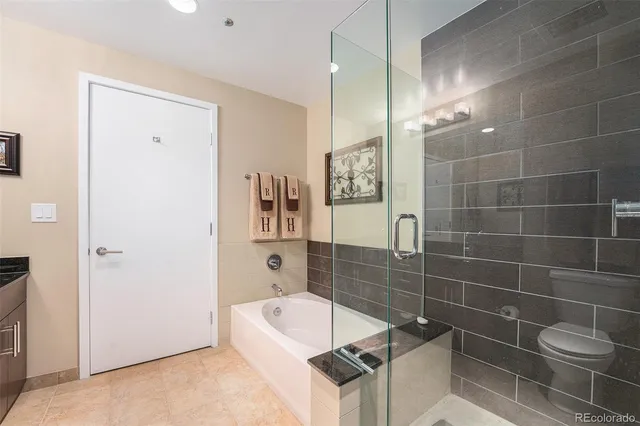 a bathroom with a bathtub a toilet and a shower