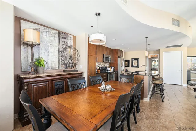 a dining table with chairs and window