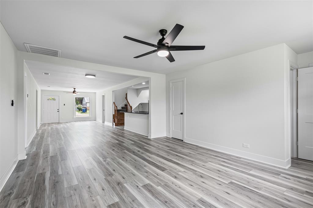2327 Brookfield Avenue Dallas, TX 75235 - Photo 12 of 31 a view of a room with wooden floor and a ceiling fan