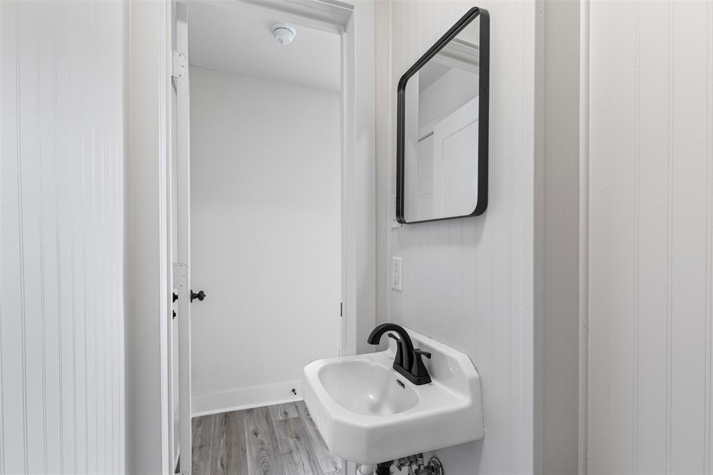 2327 Brookfield Avenue Dallas, TX 75235 - Photo 13 of 31 a bathroom with a sink and mirror