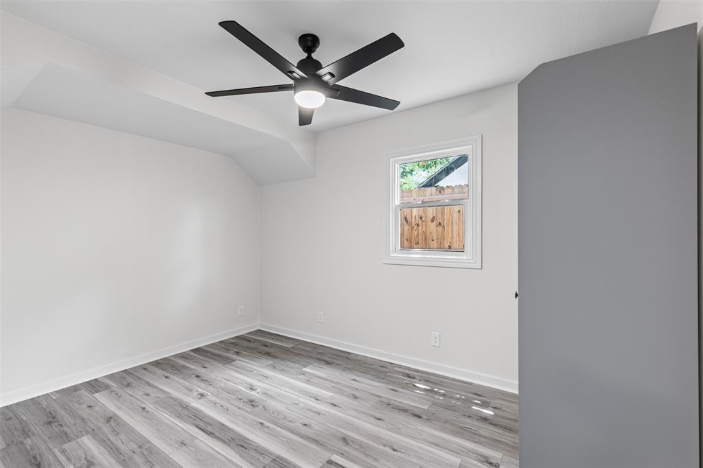 2327 Brookfield Avenue Dallas, TX 75235 - Photo 14 of 31 an empty room with wooden floor and windows