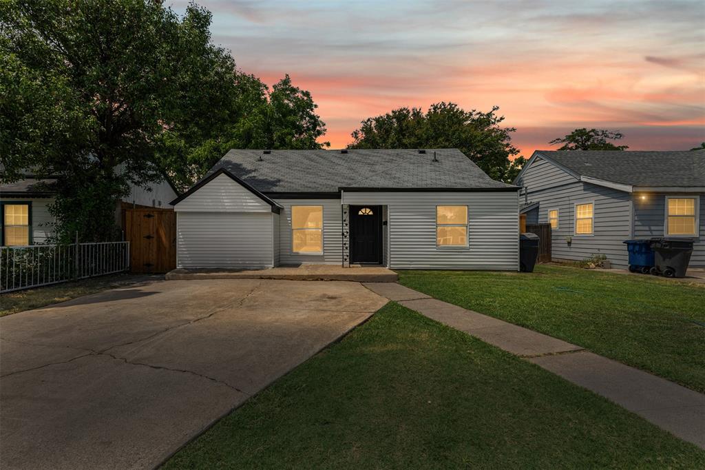 2327 Brookfield Avenue Dallas, TX 75235 - Photo 2 of 31 a front view of a house with a yard and garage