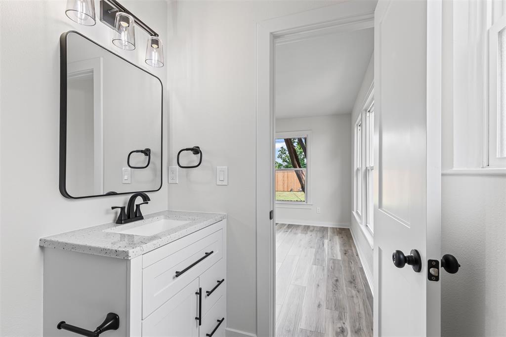 2327 Brookfield Avenue Dallas, TX 75235 - Photo 21 of 31 a bathroom with a sink a mirror and shower