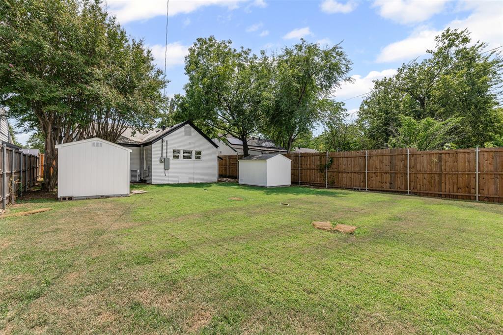 2327 Brookfield Avenue Dallas, TX 75235 - Photo 27 of 31 a house with a tree and a yard