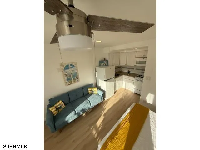 a bedroom with a bed and ceiling fan