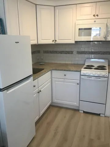 a kitchen with cabinets appliances