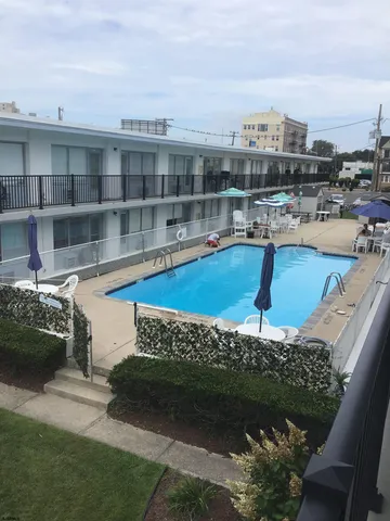 a view of a swimming pool with a patio