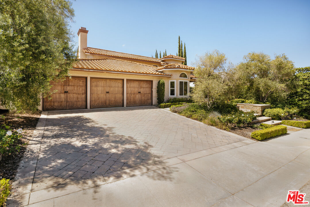 5120 Lafitte Drive Oak Park, CA 91377 - Photo 3 of 7 a front view of a house with a yard and garage