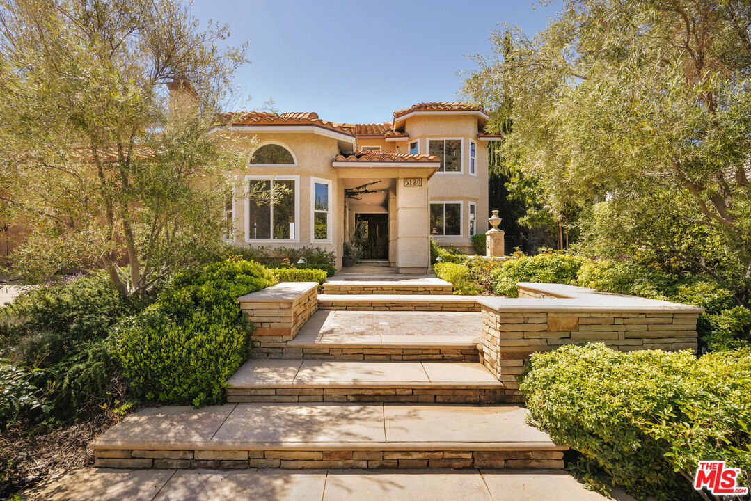 5120 Lafitte Drive Oak Park, CA 91377 - Photo 4 of 7 a front view of a house with garden
