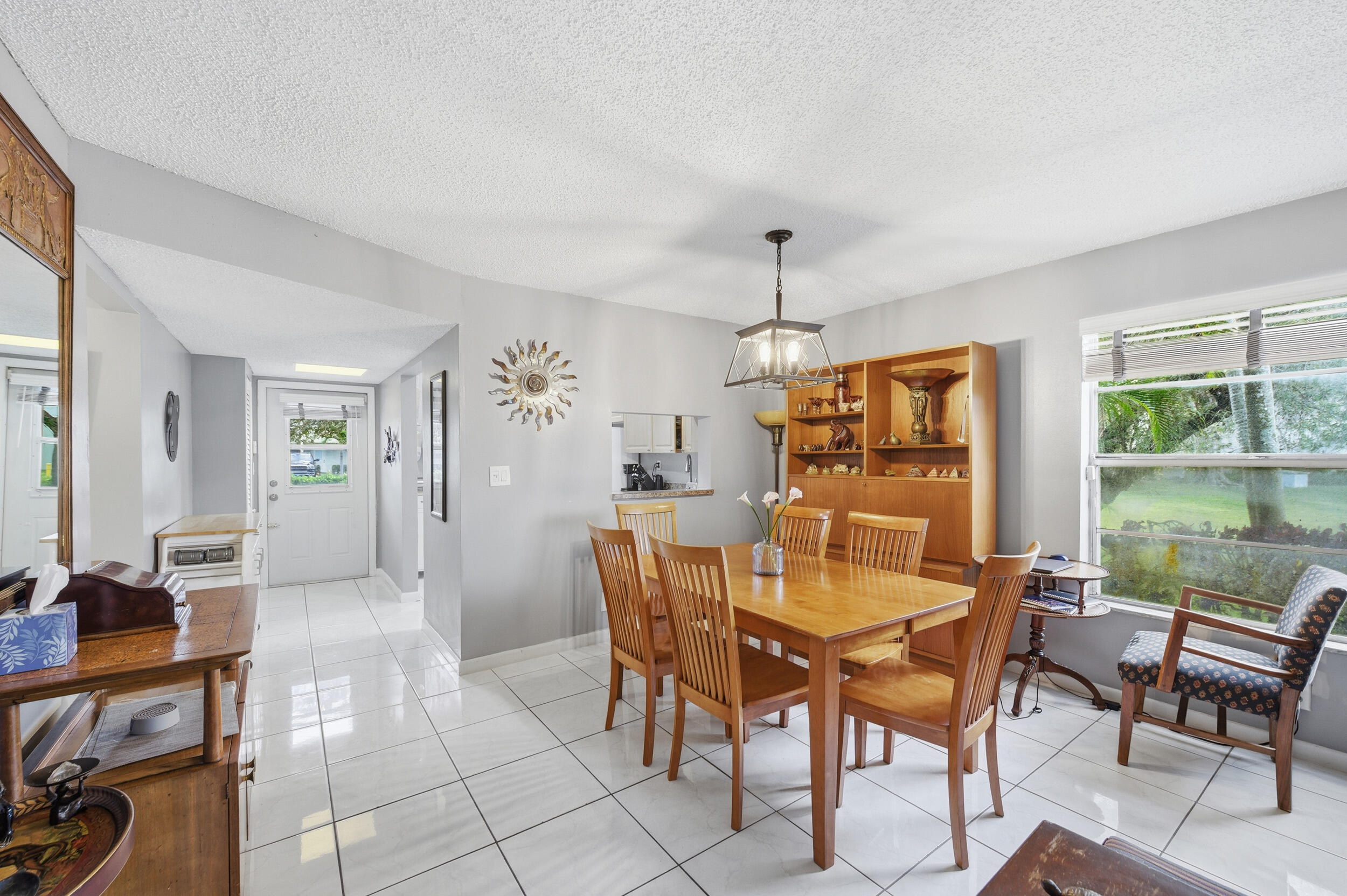 2600 Fiore Way, Unit 101C Delray Beach, FL 33445 - Photo 12 of 40 a view of a dining room with furniture window and outside view