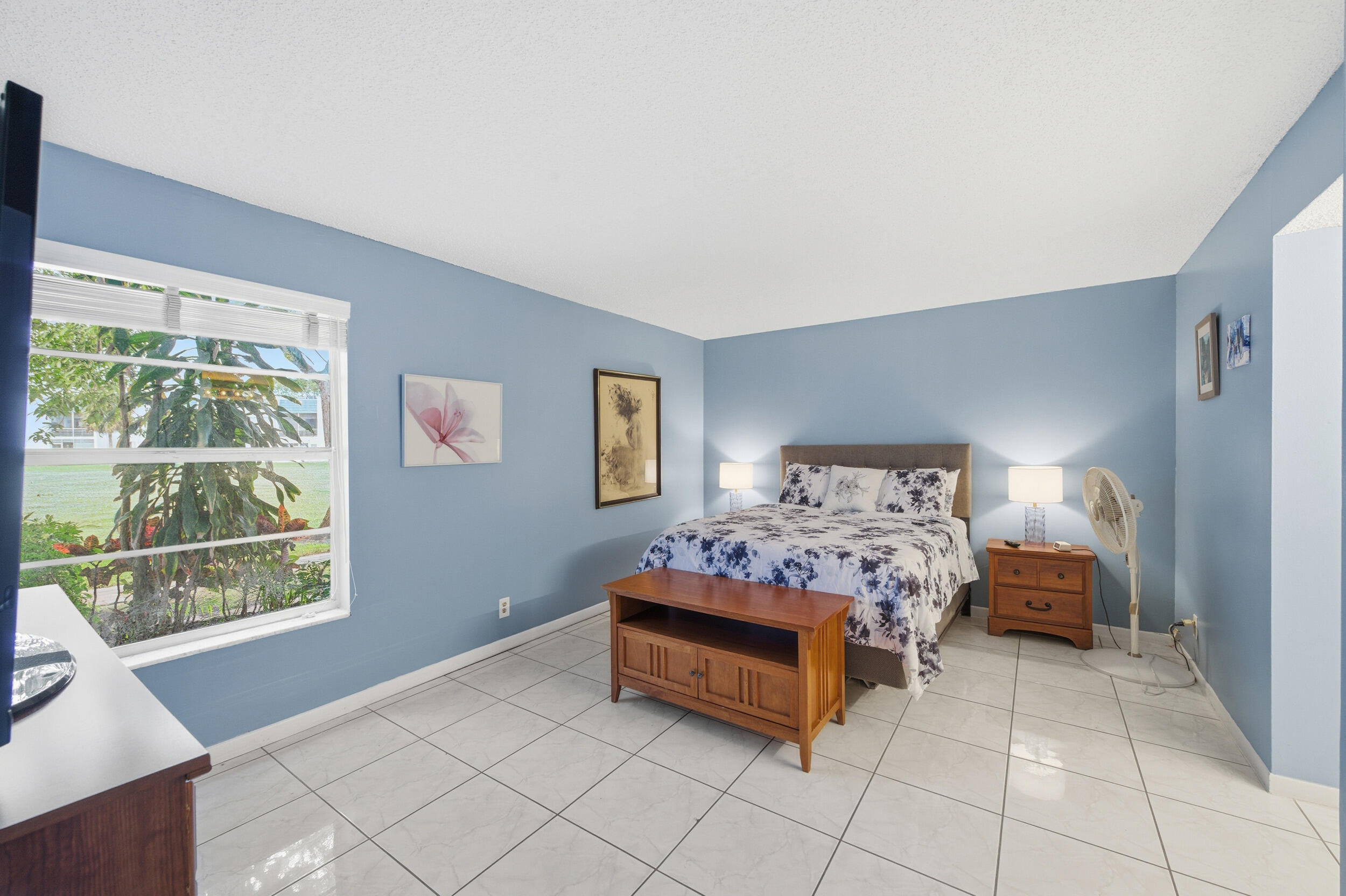 2600 Fiore Way, Unit 101C Delray Beach, FL 33445 - Photo 18 of 40 a bedroom with a bed and a window