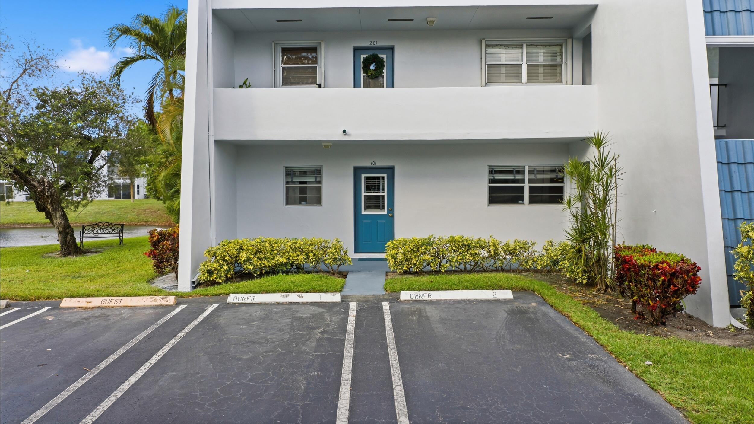 2600 Fiore Way, Unit 101C Delray Beach, FL 33445 - Photo 2 of 40 front view of a house with a yard