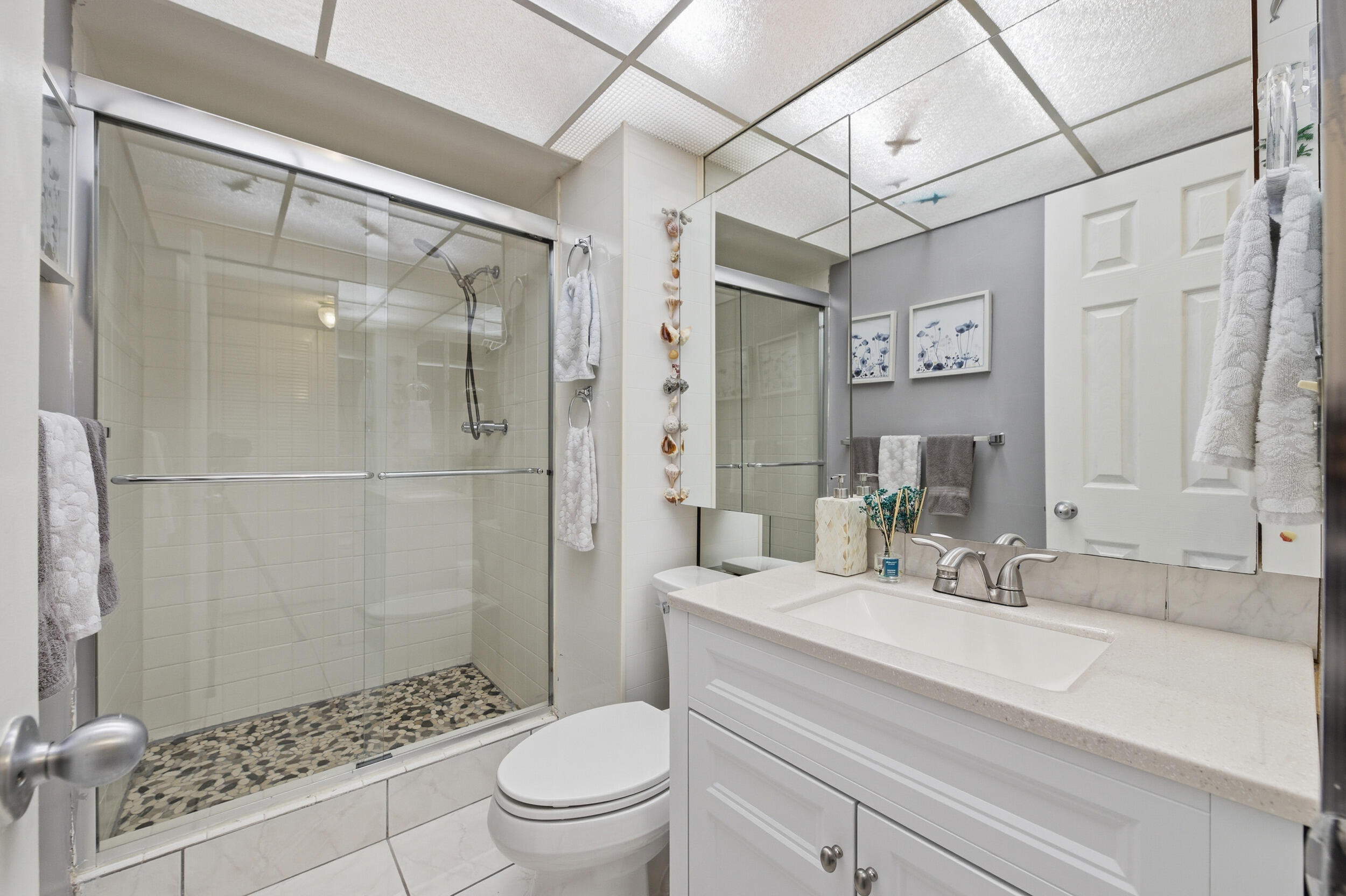2600 Fiore Way, Unit 101C Delray Beach, FL 33445 - Photo 24 of 40 a bathroom with a sink toilet and shower