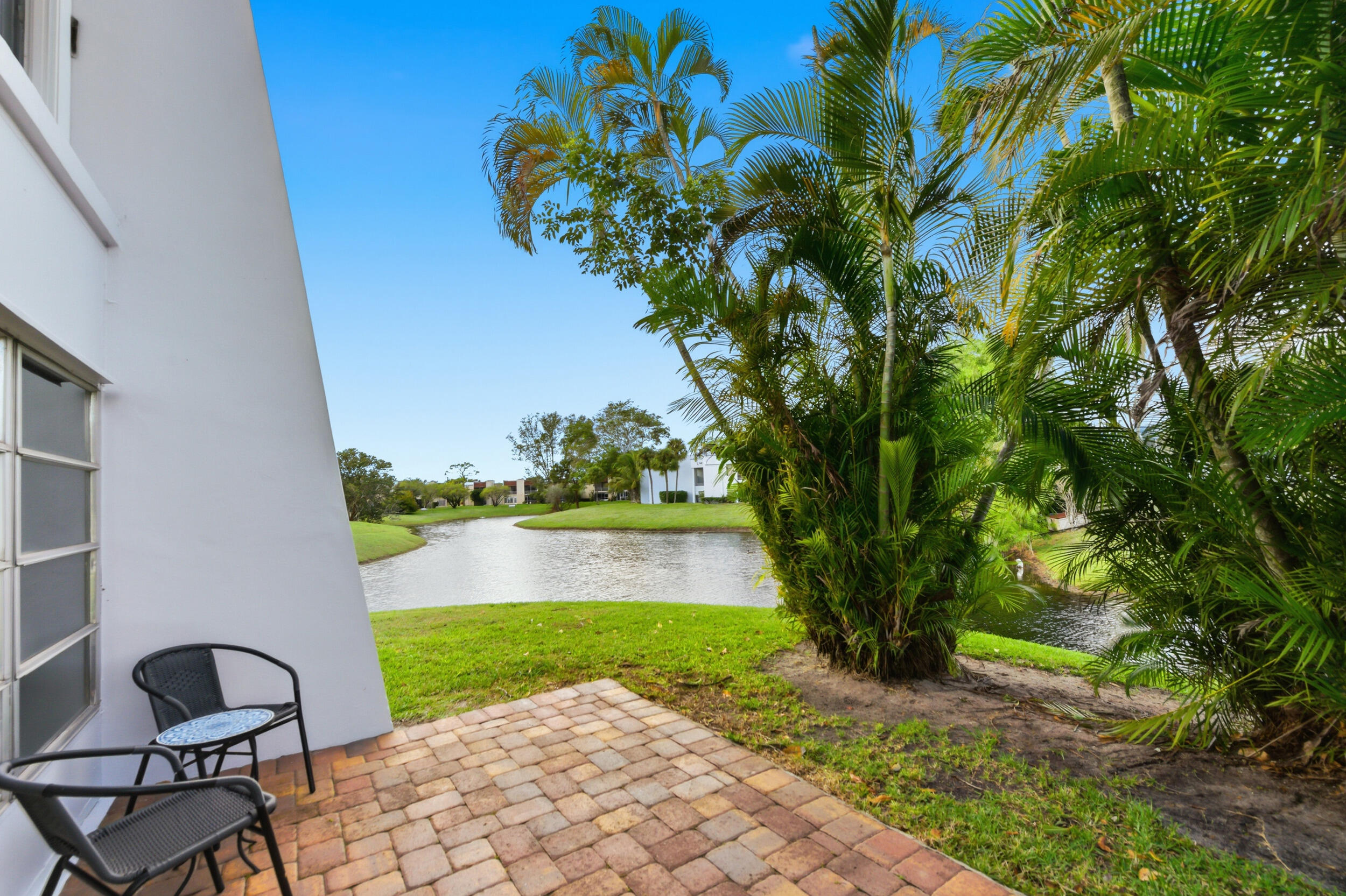 2600 Fiore Way, Unit 101C Delray Beach, FL 33445 - Photo 28 of 40 a view of a back yard of the house