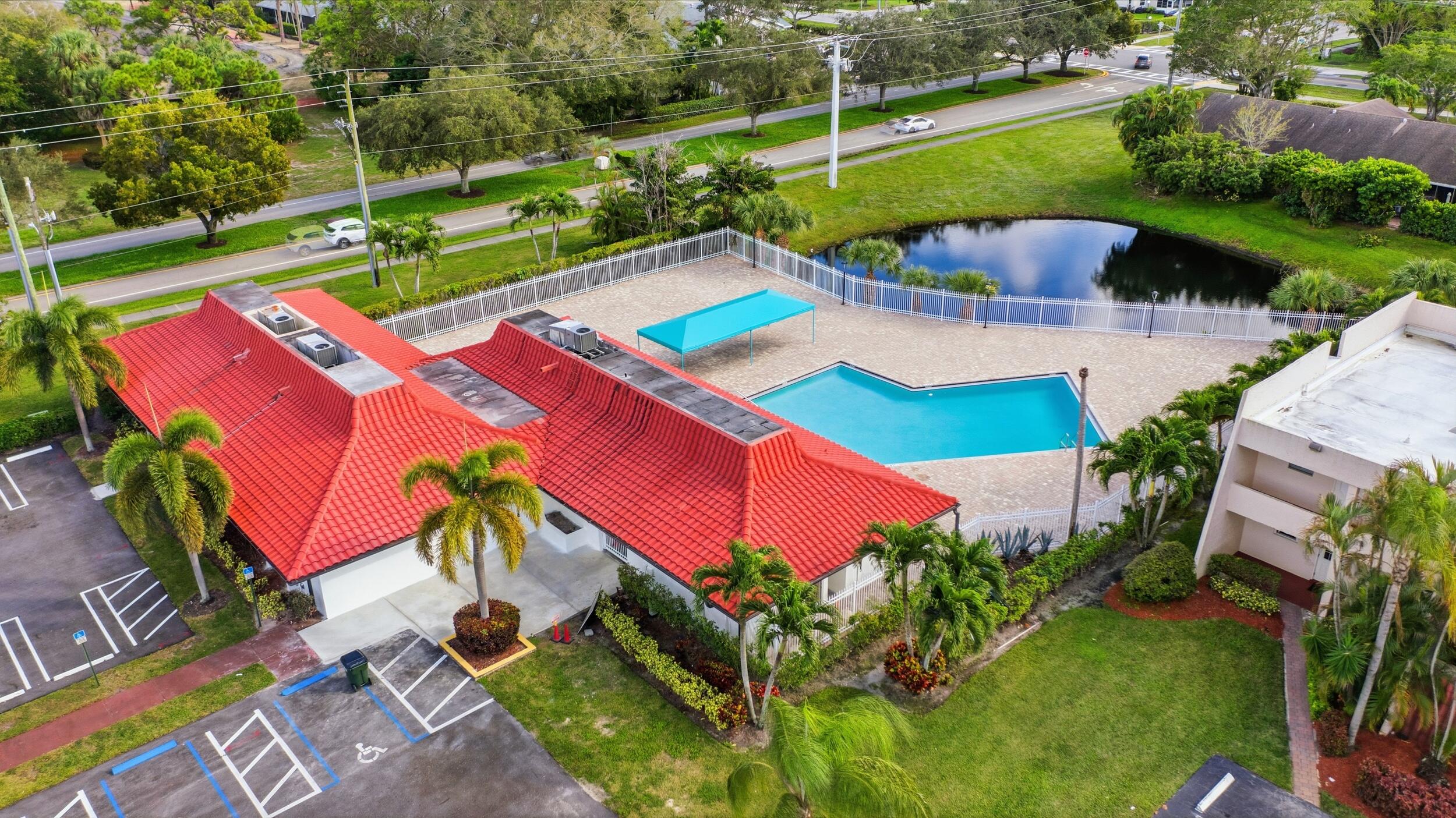 2600 Fiore Way, Unit 101C Delray Beach, FL 33445 - Photo 29 of 40 an aerial view of a house with a yard basket ball court and outdoor seating