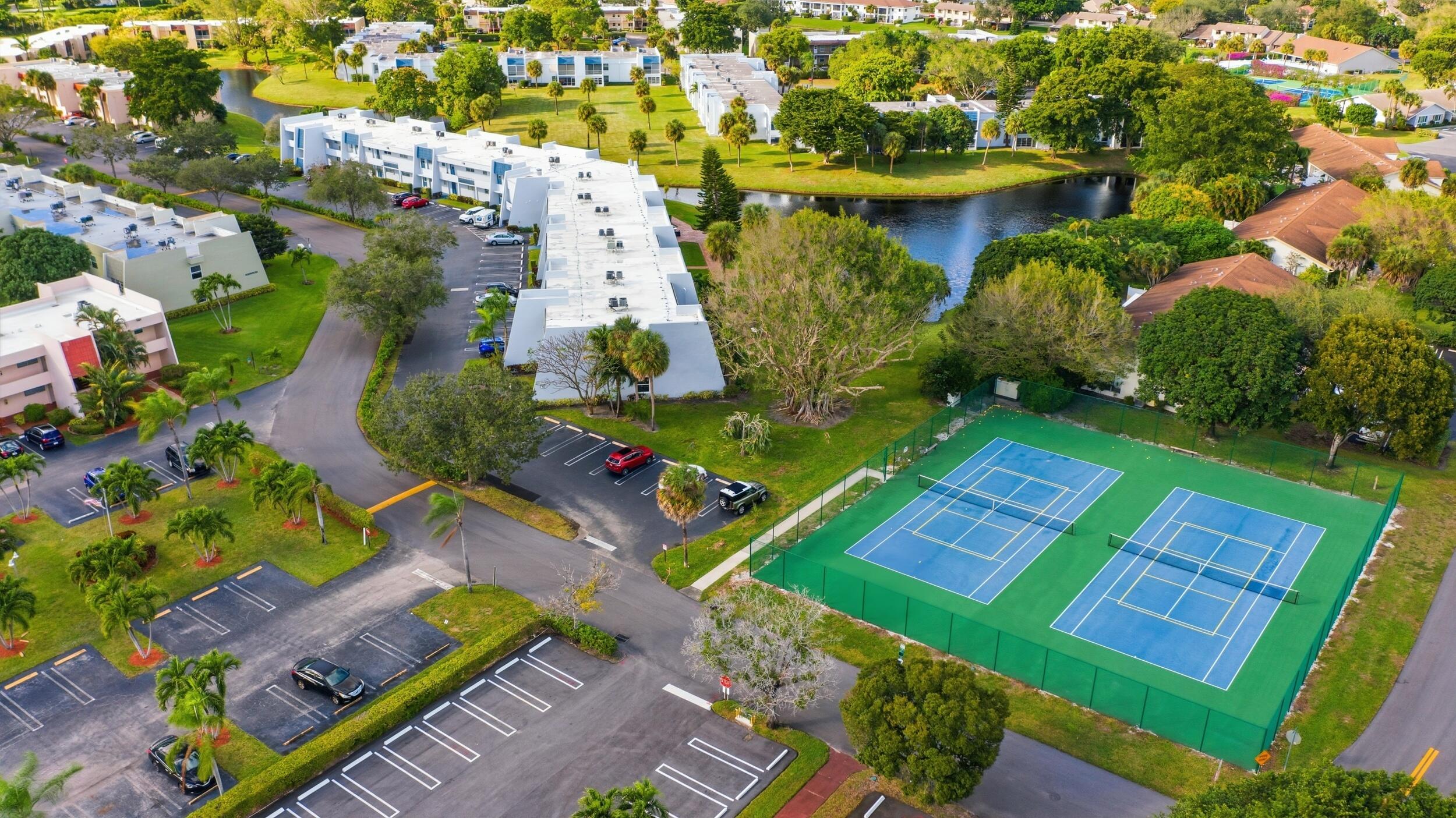 2600 Fiore Way, Unit 101C Delray Beach, FL 33445 - Photo 33 of 40 a view of a yard with plants and large trees