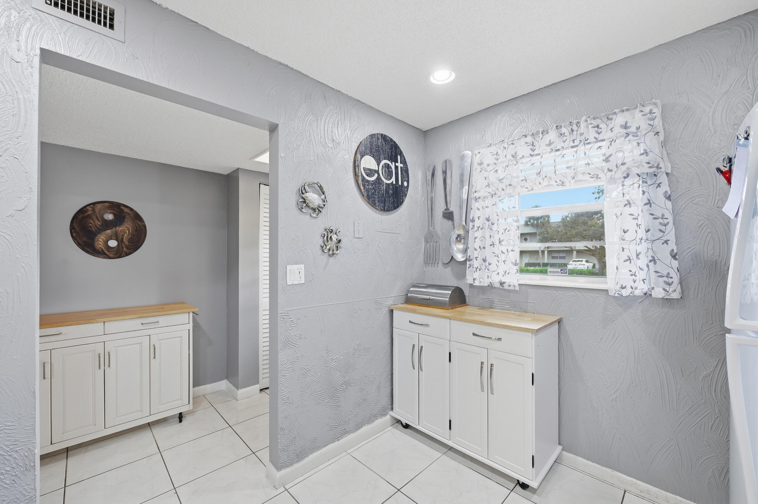 2600 Fiore Way, Unit 101C Delray Beach, FL 33445 - Photo 8 of 40 a bathroom with a sink a vanity and a mirror