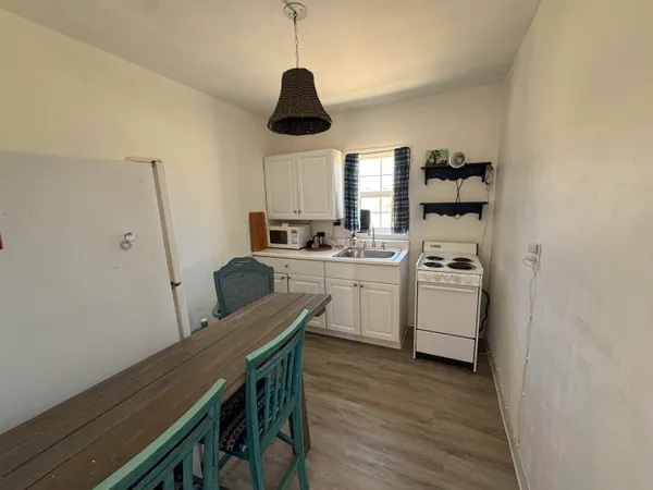a view of bedroom with a bed and wooden floor