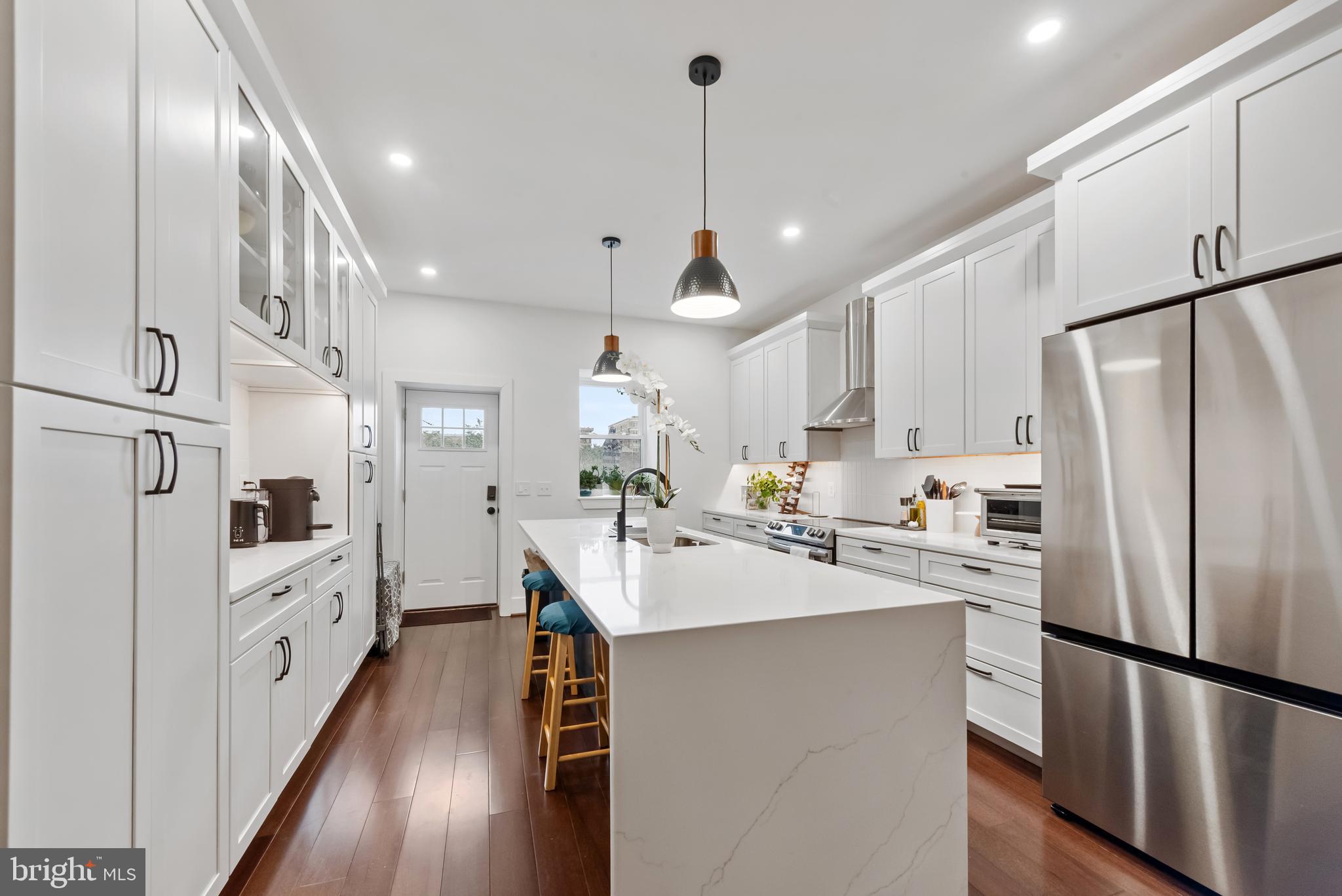 3461 Keswick Road Baltimore, MD 21211 - Photo 9 of 33 a kitchen with white cabinets and stainless steel appliances