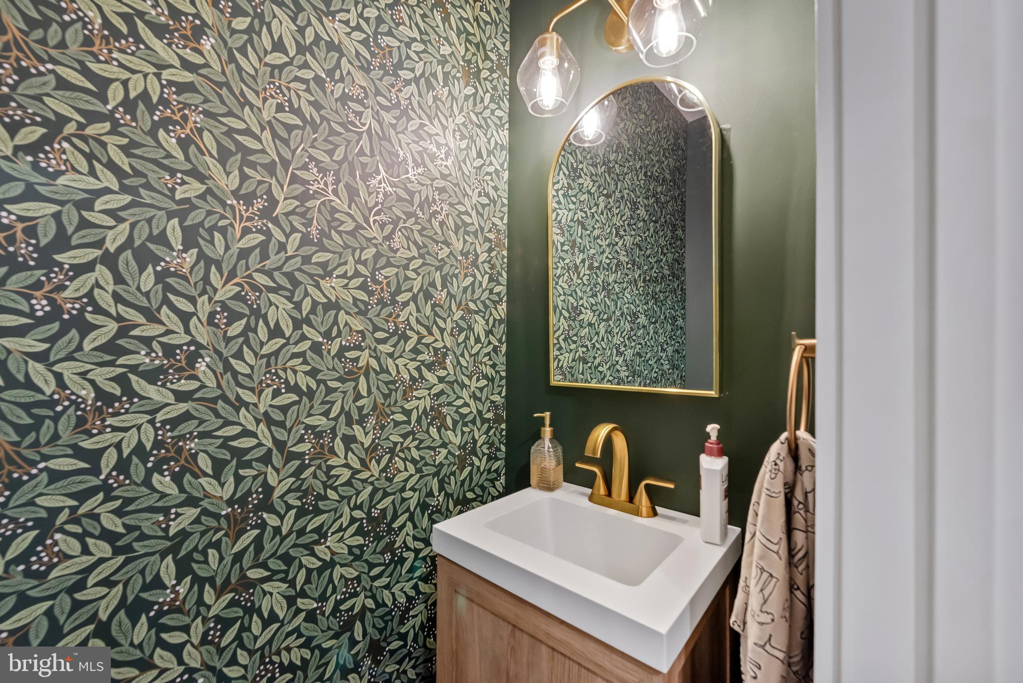 3461 Keswick Road Baltimore, MD 21211 - Photo 10 of 33 a bathroom with a sink a mirror and a shower