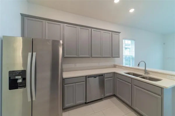 a kitchen with a sink and refrigerator