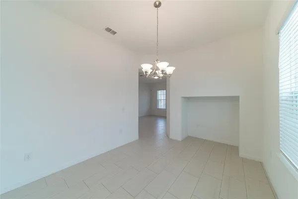 a view of a chandelier in big room and chandelier fan