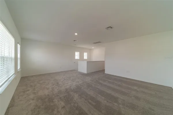 an empty room with windows and pillars in it