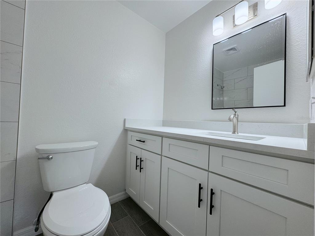 1013 South Hiawassee Road, Unit 3635 Orlando, FL 32835 - Photo 13 of 20 a bathroom with a toilet sink and mirror