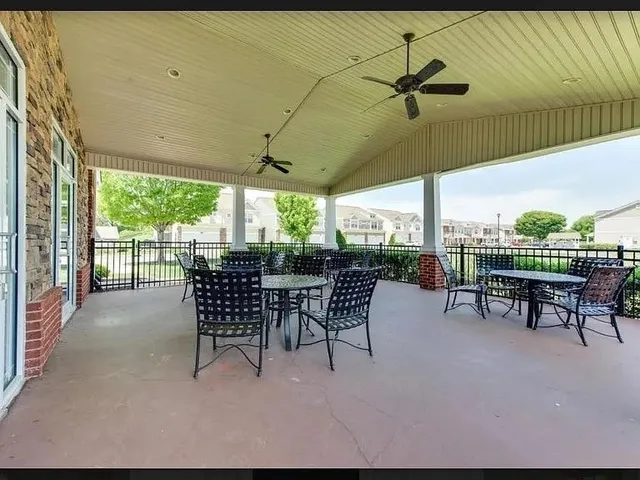 a view of a patio with table and chairs