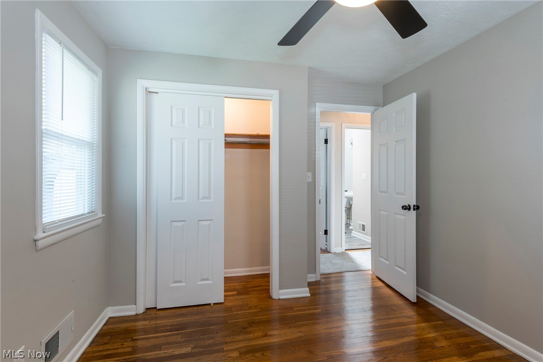13175 McCracken Road Cleveland, OH 44125 - Photo 19 of 48 Bededroom featuring a closet, ceiling fan, and dark wood-type flooring
