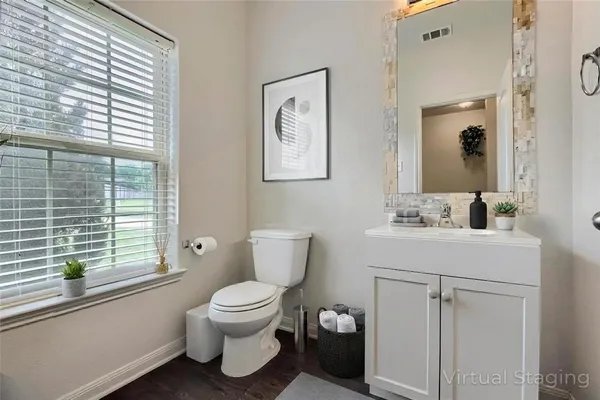 a bathroom with a toilet sink and mirror
