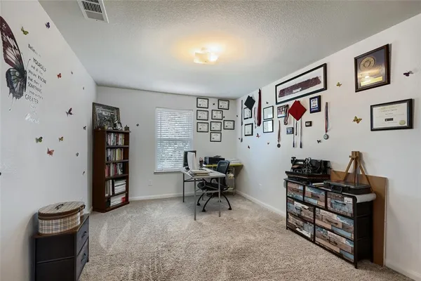 a living room with furniture and book shelf