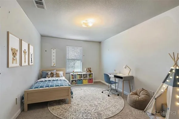 a bed room with a bed and a chair